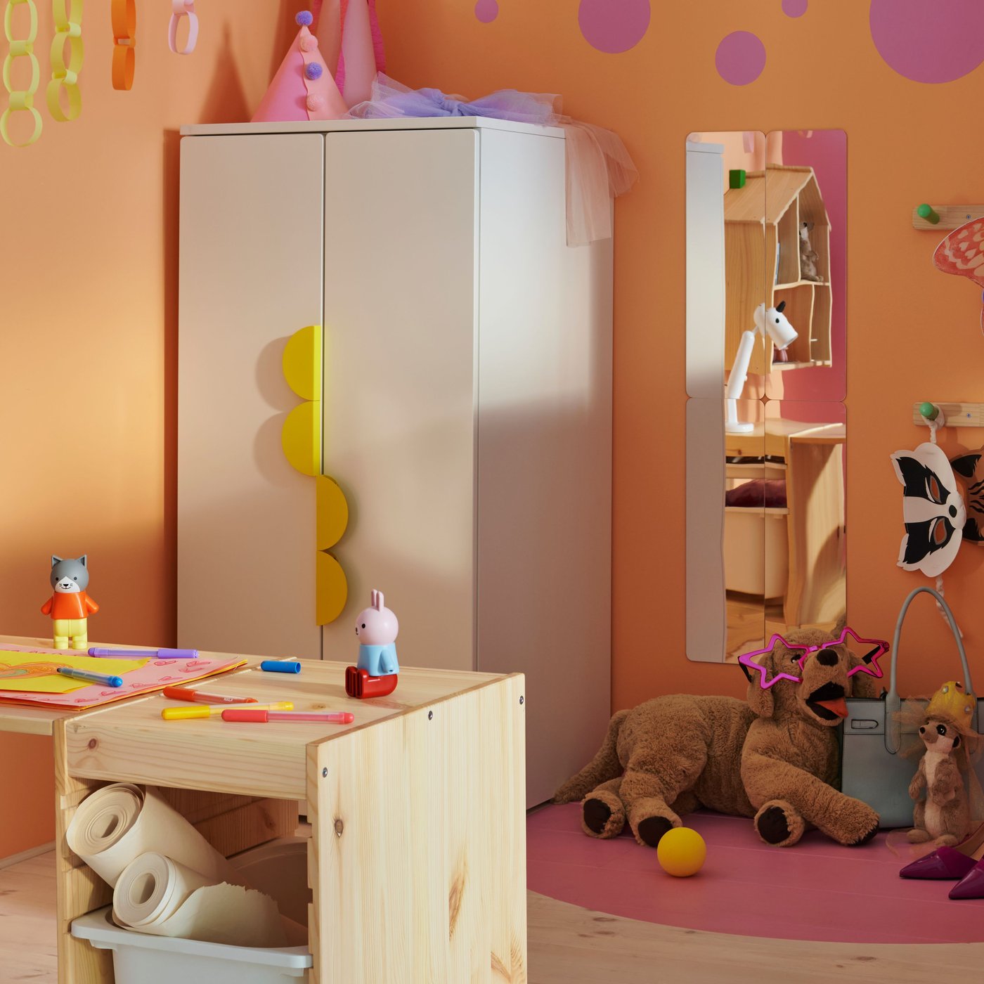 Un cadre et un plateau TROFAST en pin blanc clair composent un bureau dans une chambre d'enfant avec une armoire SMÅSTAD/PLATSA.
