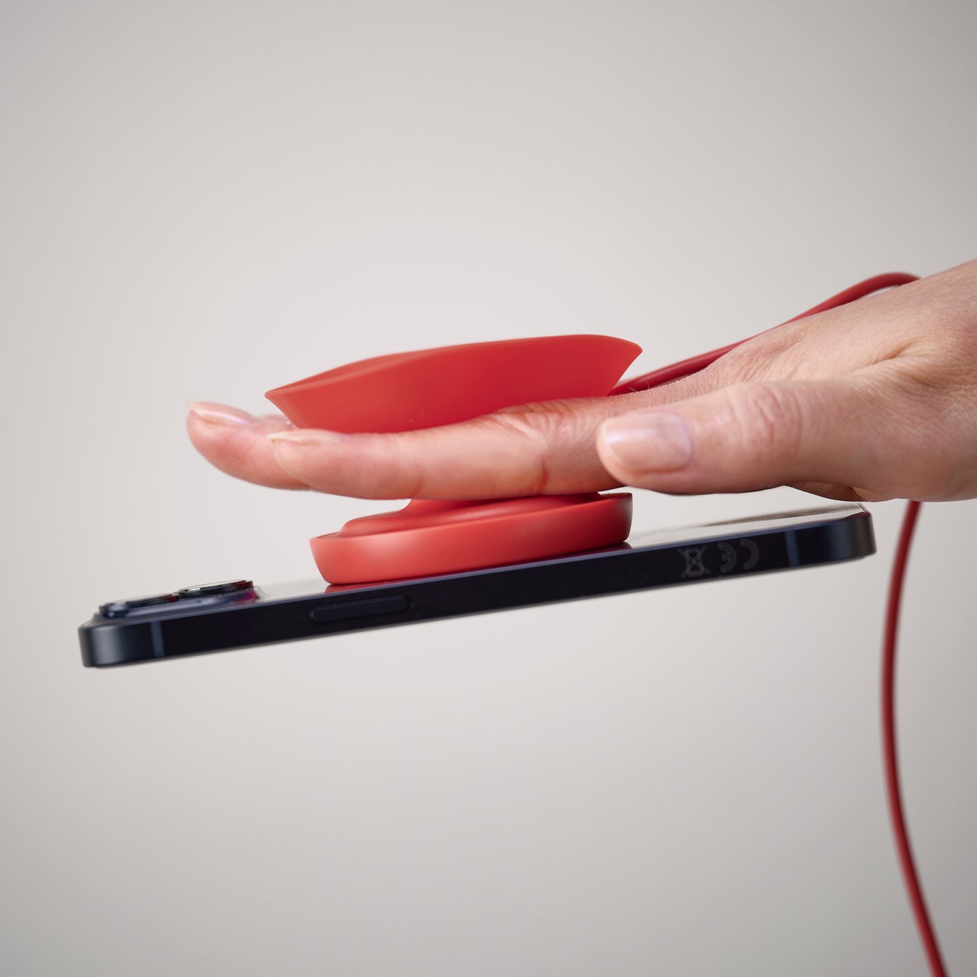 VÄSTMÄRKE wireless magnetic charger, red, with cable.