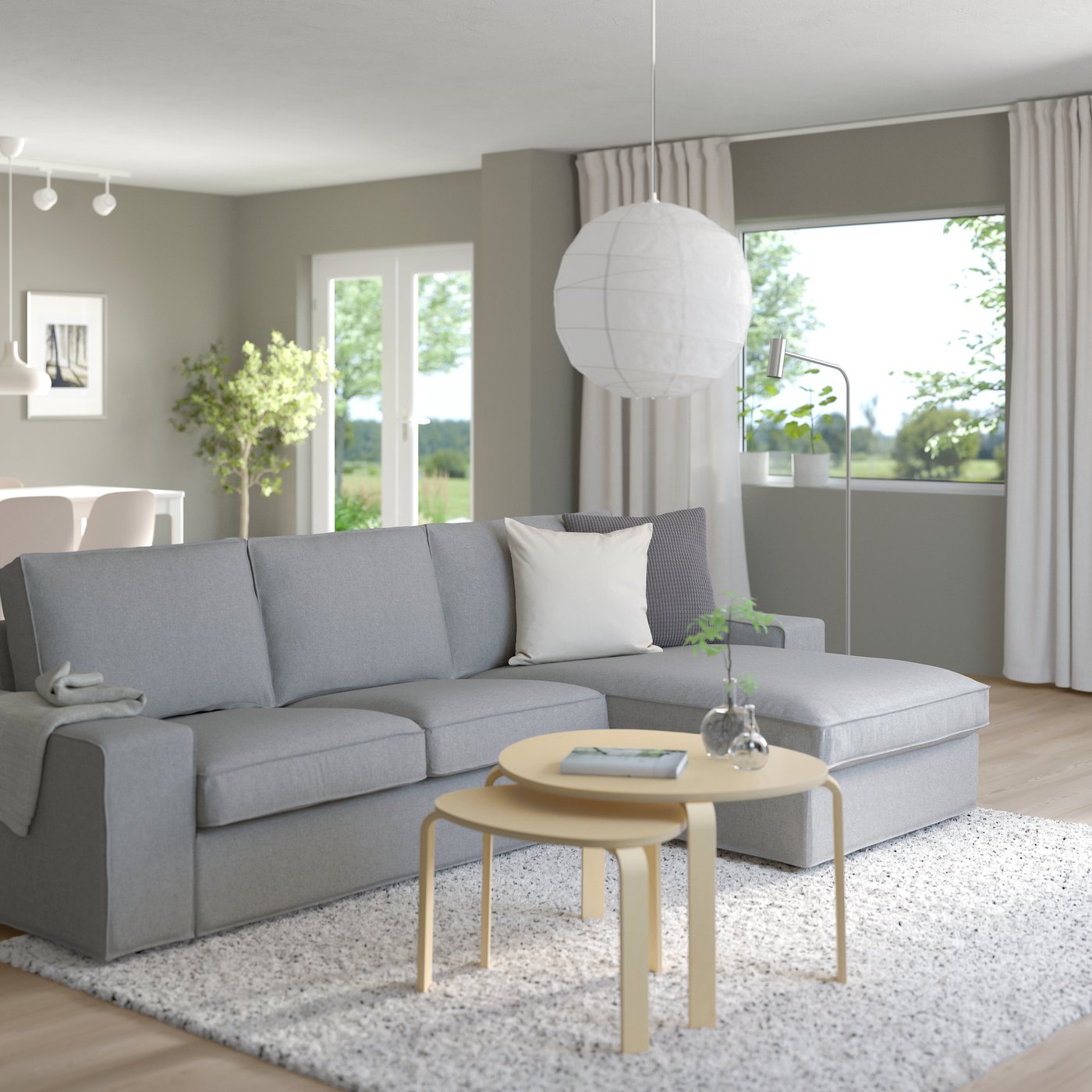 A Tibbleby beige/grey KIVIK 3-seat sofa with chaise longue in the living room