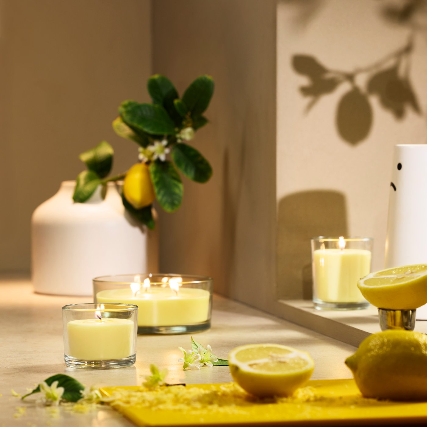 A Citrus flower light yellow LOTSFÅGEL scented candle in glass, 3 wicks