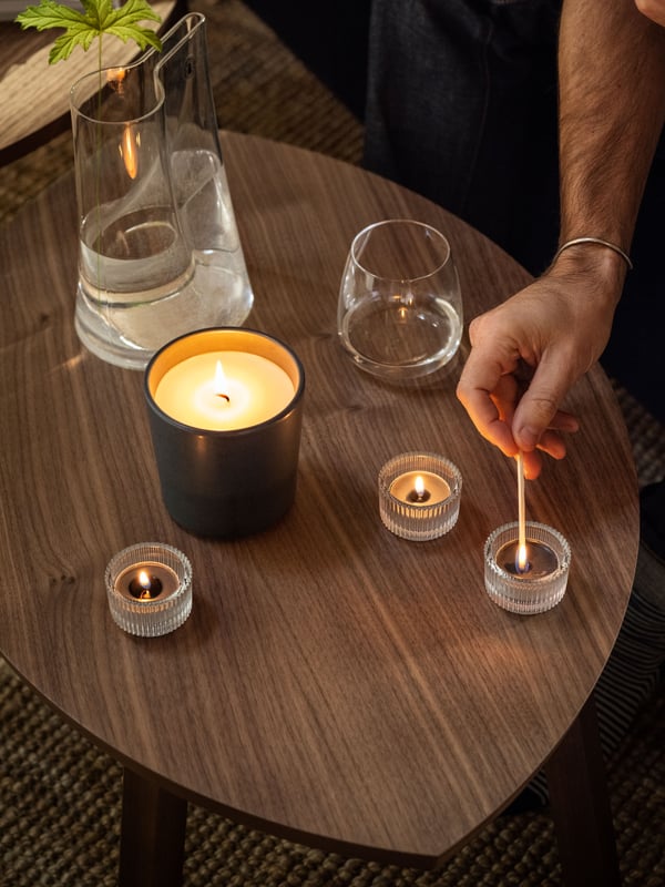 A Vetiver & geranium/black-turquoise FRUKTSKOG scented candle in ceramic jar