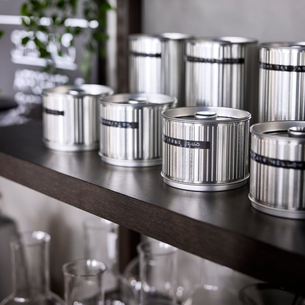 Various tea storage tins on a shelf