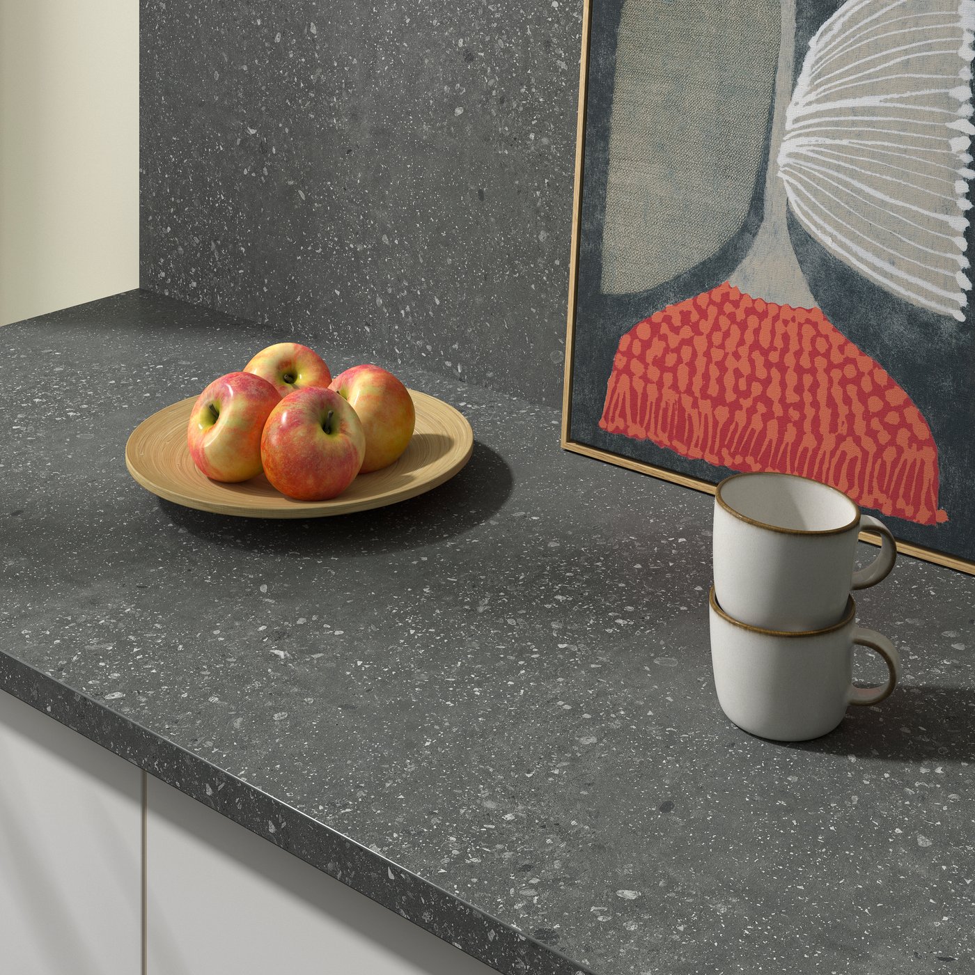 SIBBARP wall panel and countertop, with a plate of four apples, two cups, and a picture in the background.