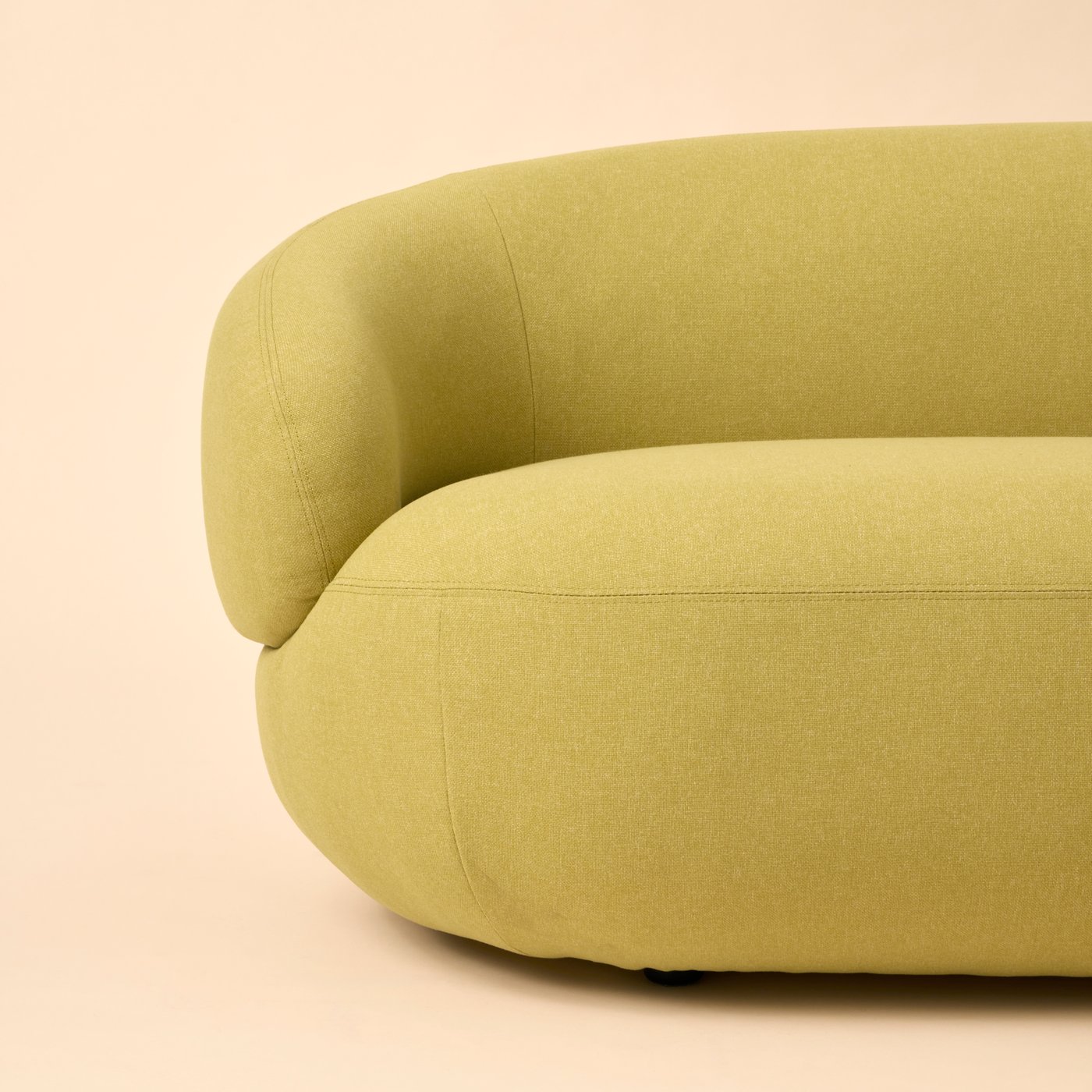 Part of a bright-green-yellow LILLESÄTER three-seat sofa, placed against a pale-yellow background.