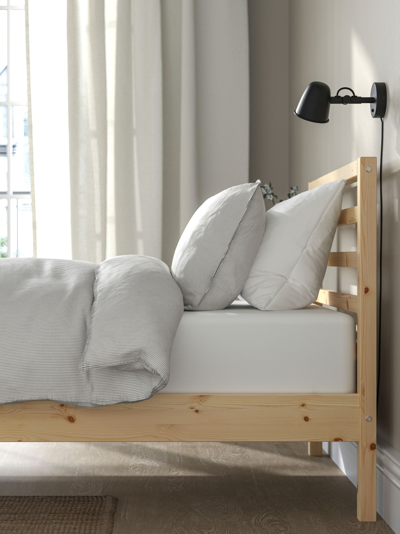 A pine TARVA bed frame in the bedroom