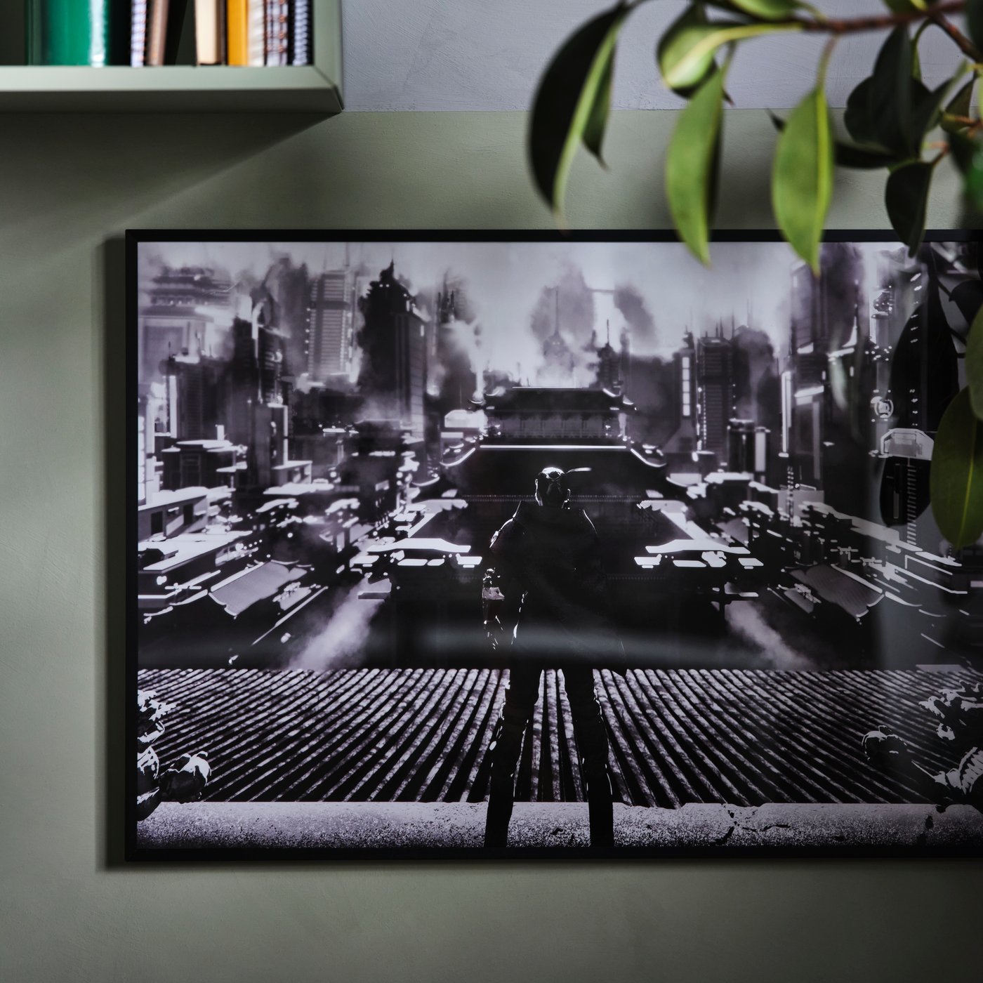 An IKEA UPPSPEL black and white poster in a black picture frame on a dark grey wall.