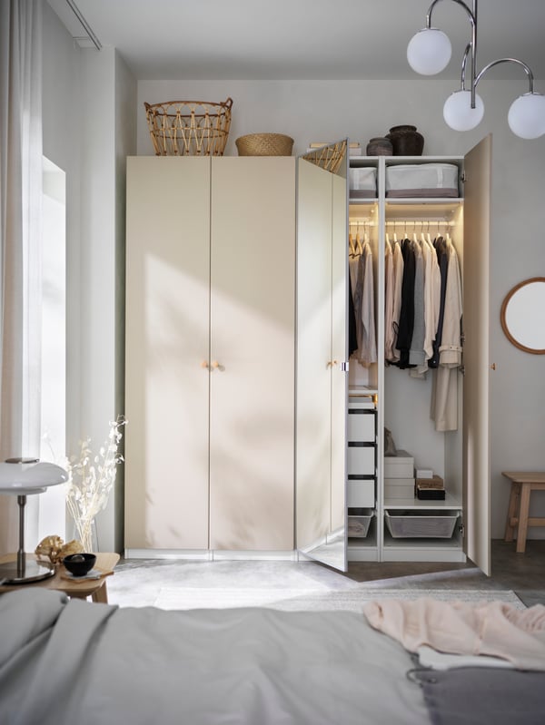 A wardrobe solution in a bedroom with a large window.