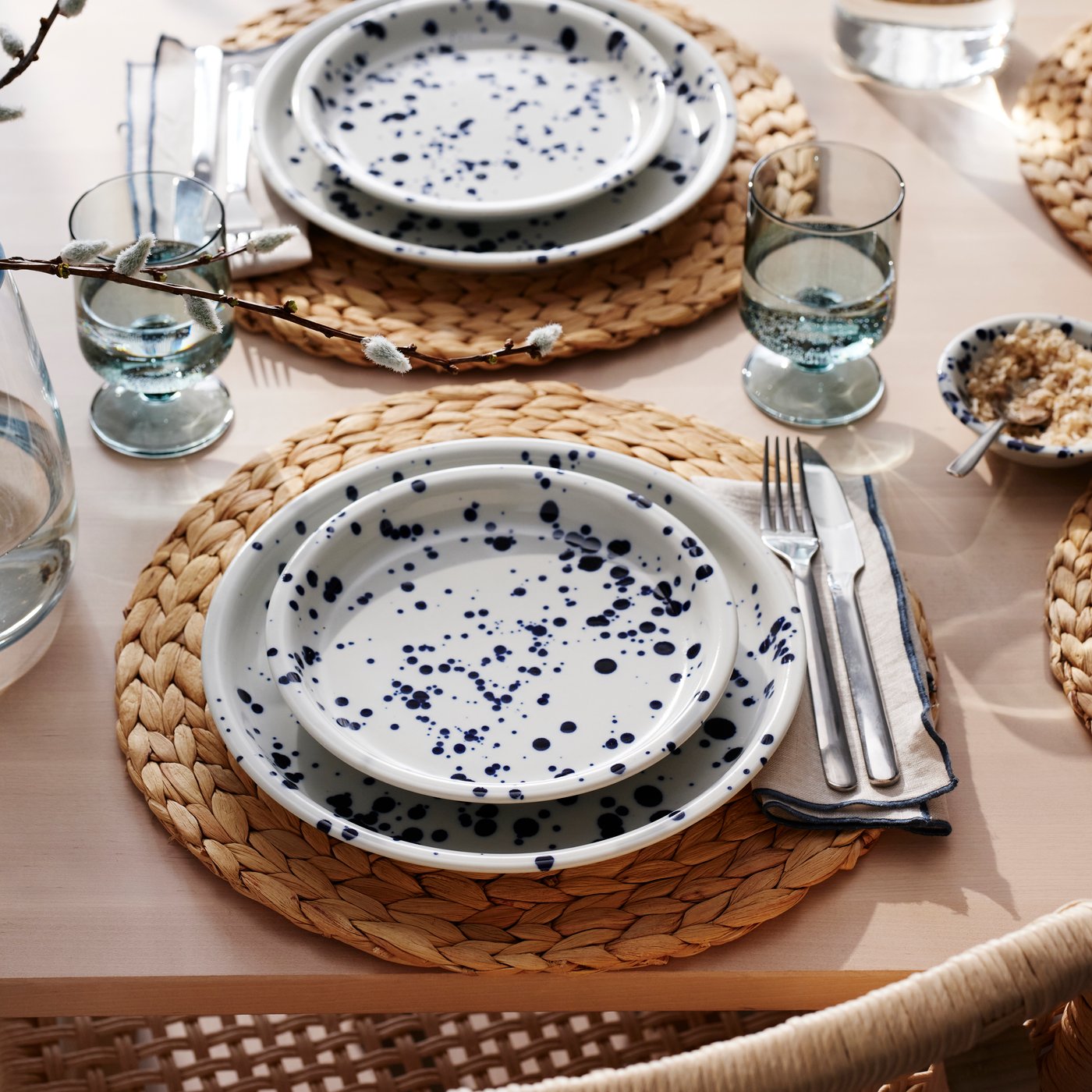 Two place settings with a patterned/blue SILVERSIDA side plate on top of a patterned/blue SILVERSIDA plate.