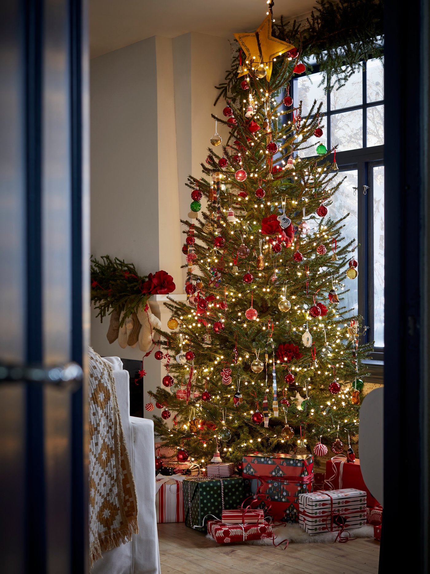 Christmas tree in traditional Scandinavian setting decorated with array of colourful VINTERFINT tree ornaments.
