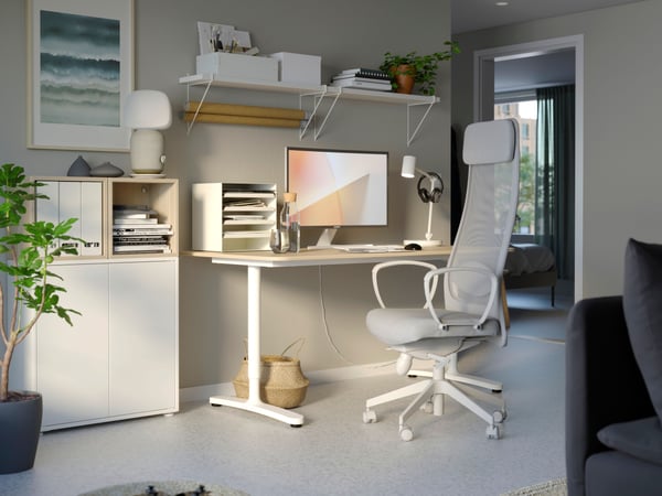 A home office with a desk and a light grey MARKUS office chair.