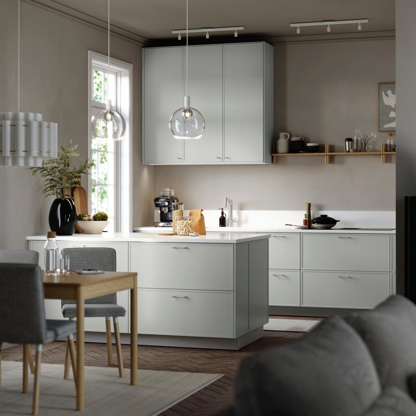 ASPUDDEN light grey kitchen fronts in a bright kitchen with white worktop, plants, dining space and pendant lamps.