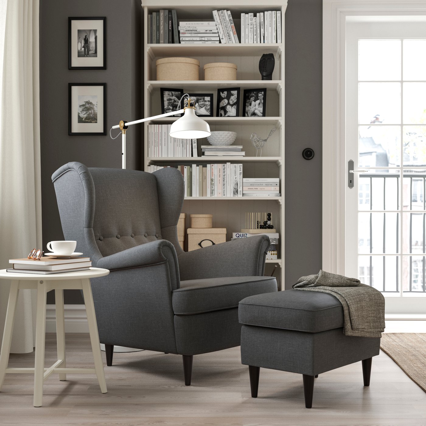 A Nordvalla dark grey STRANDMON footstool in the living room