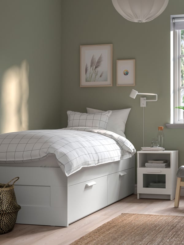 A white BRIMNES bed frame with storage
