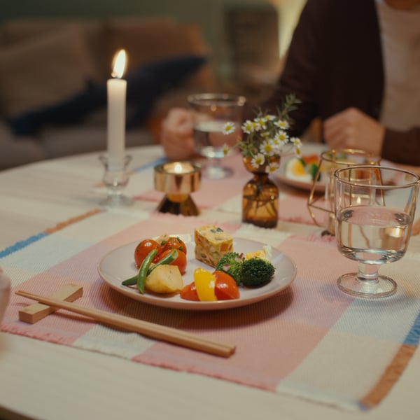 Plate with vegetables and egg dish on a candlelit table
