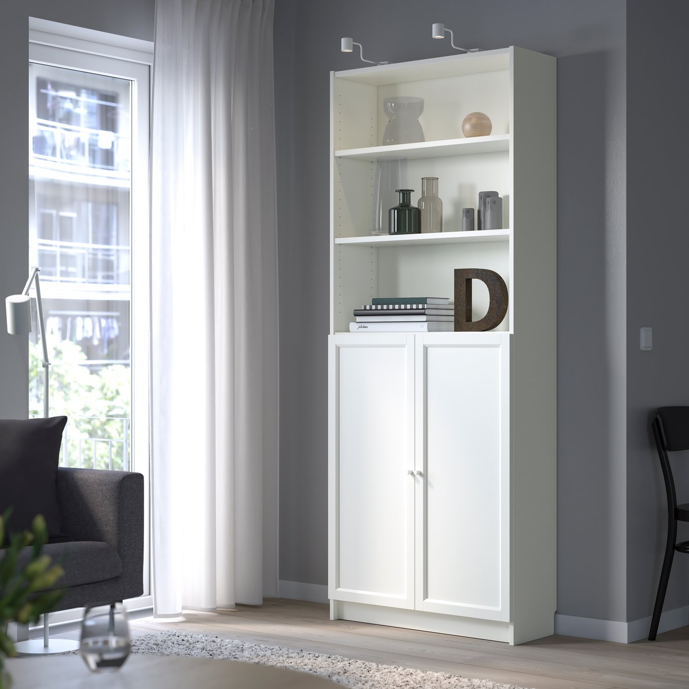 A white BILLY bookcase with doors in the living room