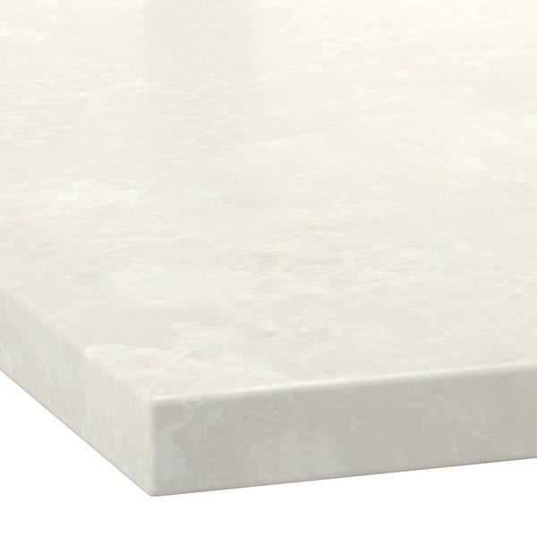 Close-up of a light beige marble-look countertop with soft white veining and a smooth, polished finish.