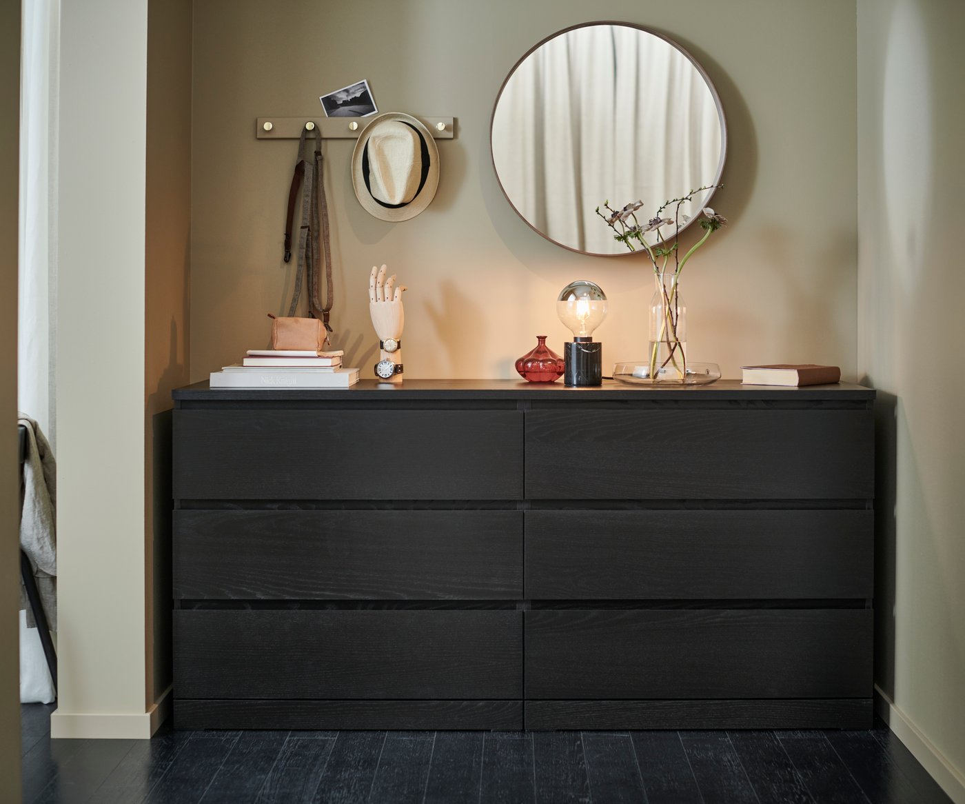 A mirror hanging above a MALM chest of drawers.