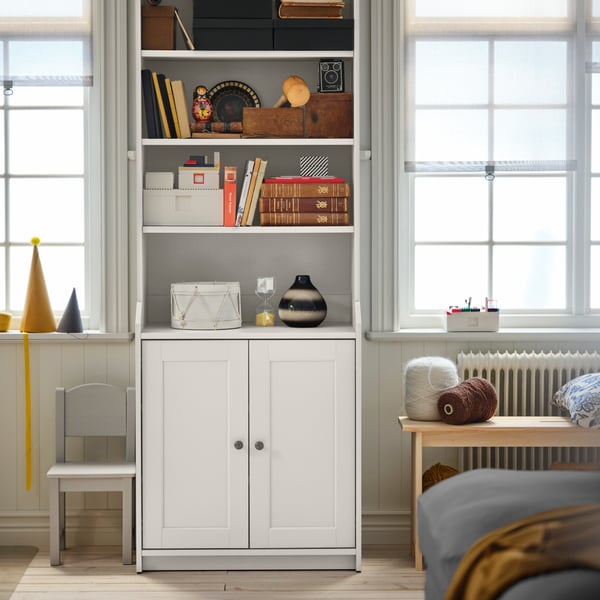 A white HAUGA high cabinet with 2 doors in the childrens room