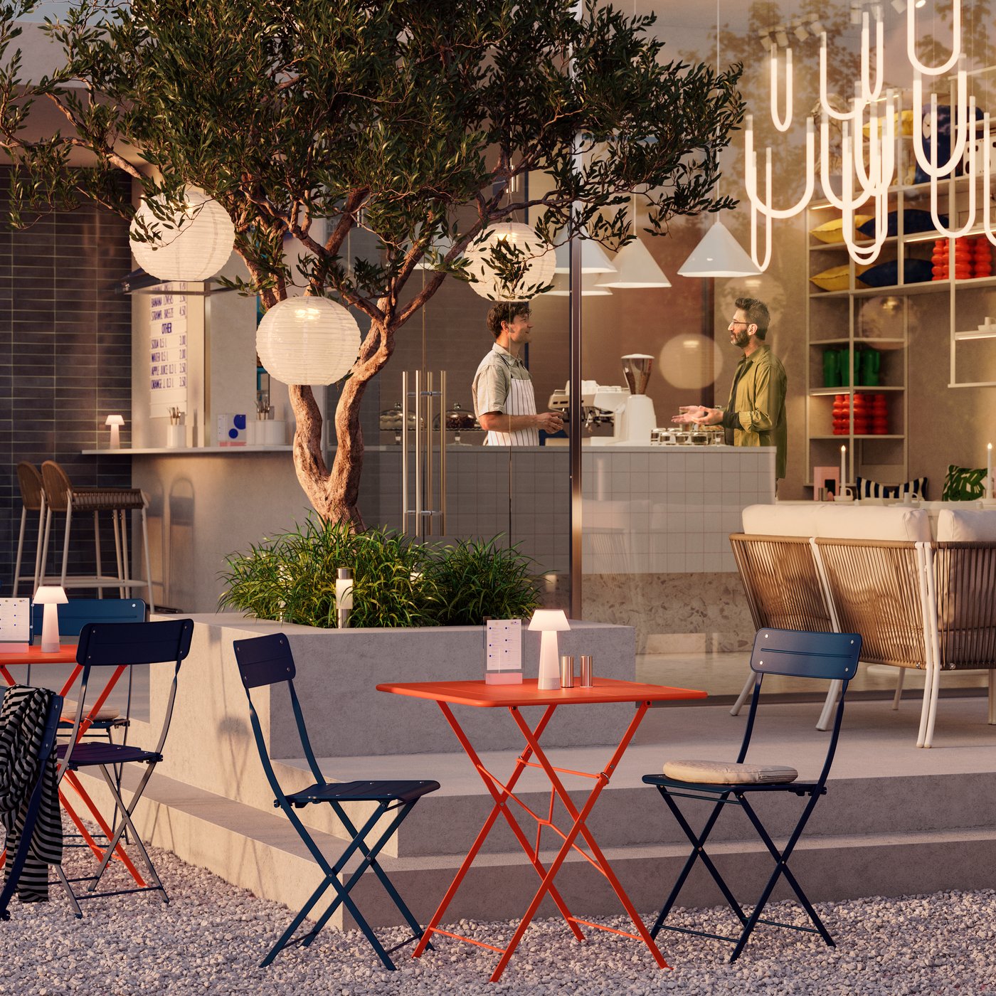 A café with an indoor and an outdoor space with trees, different lamps and SUNDSÖ bistro sets in a warm sunset light.