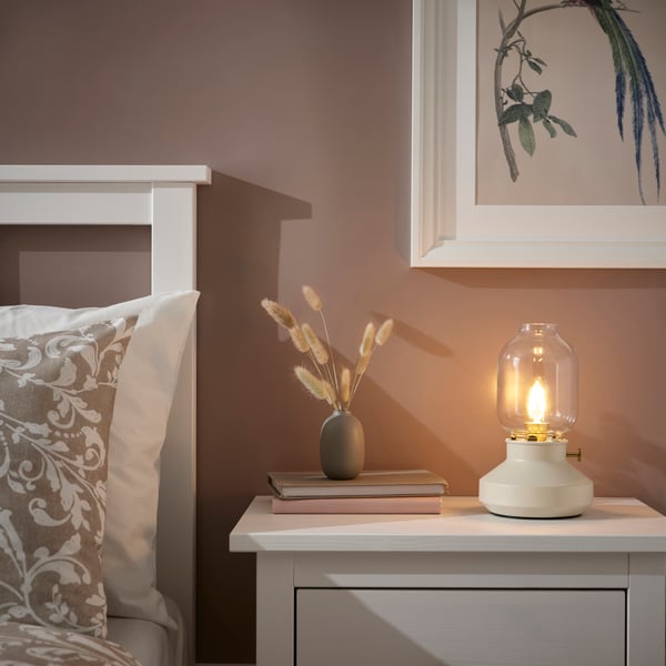TÄRNABY table lamp on a white bedside table.