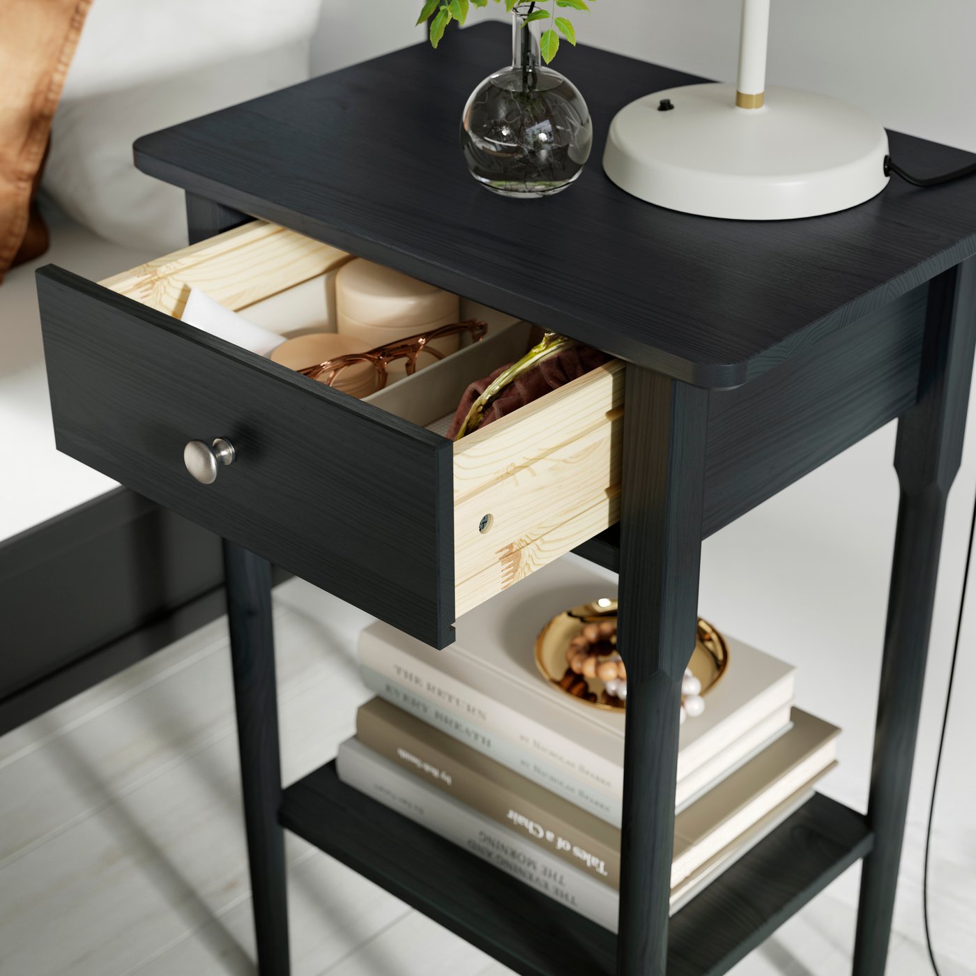 A black BLÄSTÅSEN bedside table