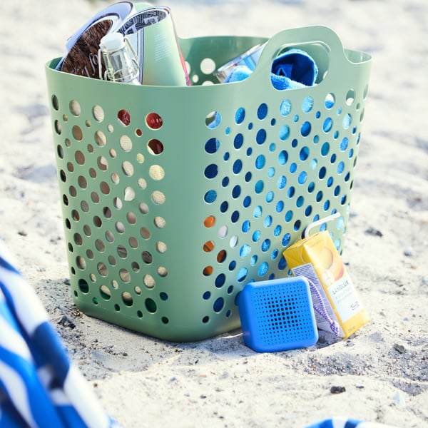 A green SLIBB flexible laundry basket in the NA