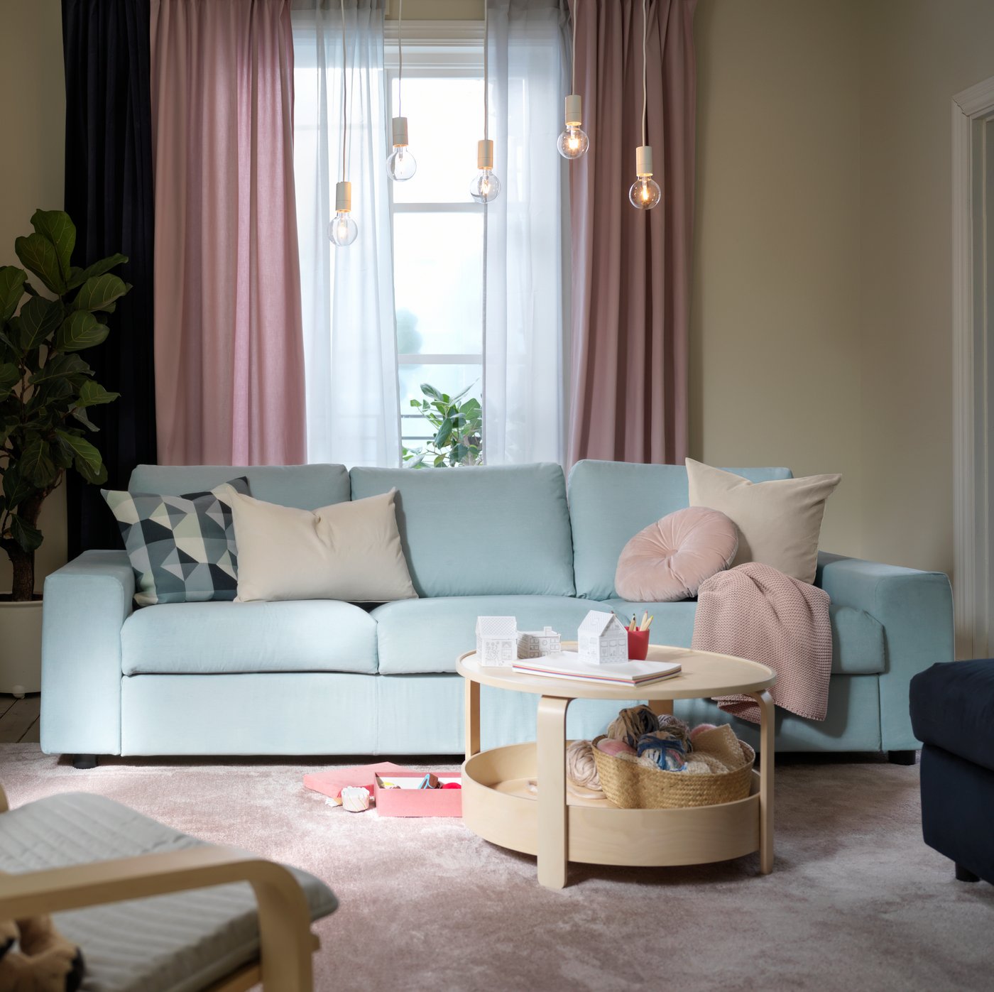 A light pink GURLI cushion cover