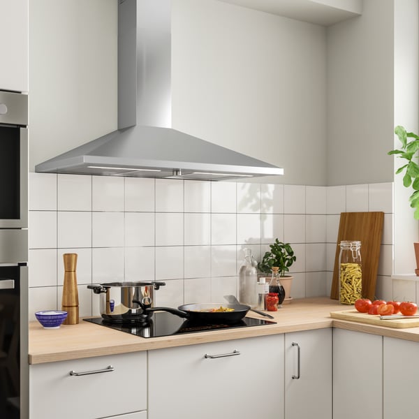 A stainless steel RYTMISK wall mounted extractor hood in the kitchen