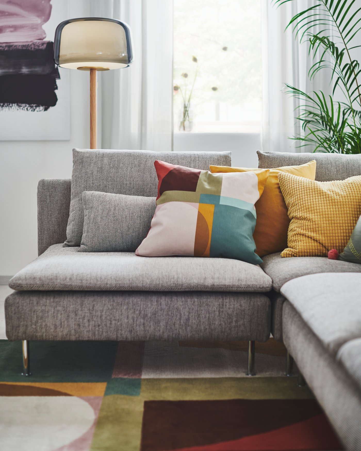 A multicolour STENMÄTARE cushion cover in the living room