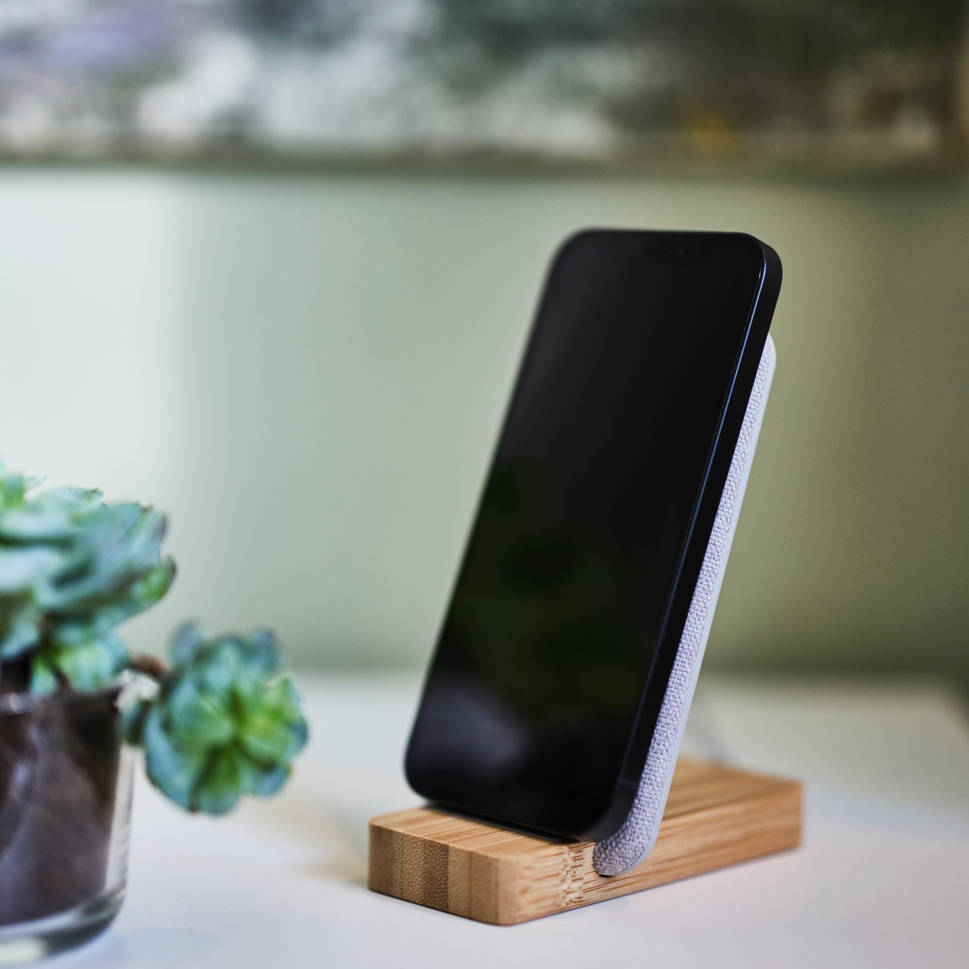 A NORDMÄRKE wireless charging stand, made of bamboo.