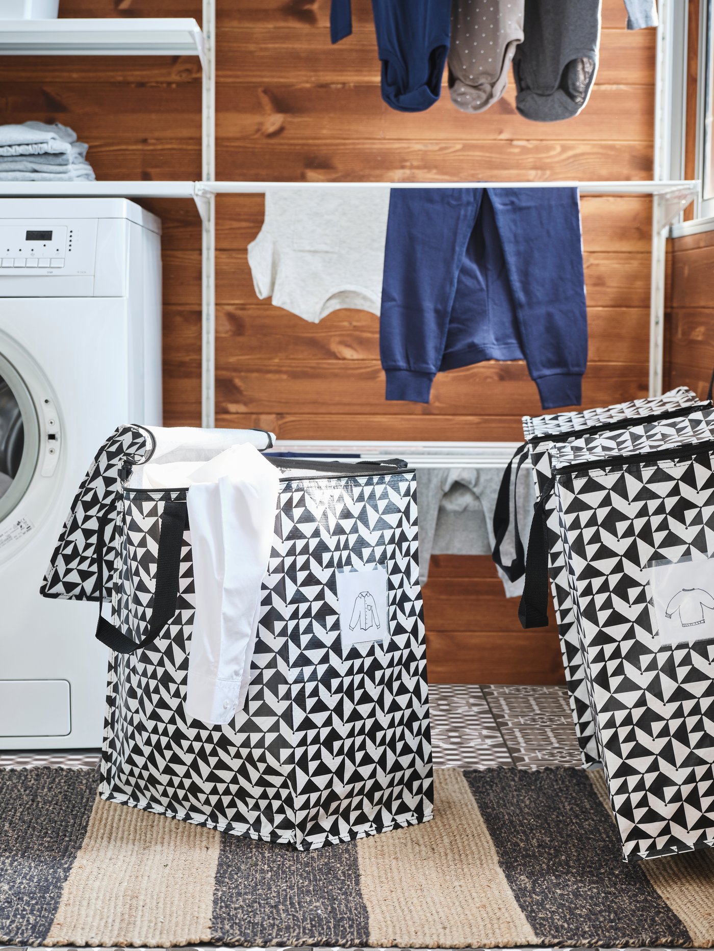 A black/beige UGILT rug, flatwoven in the laundry room
