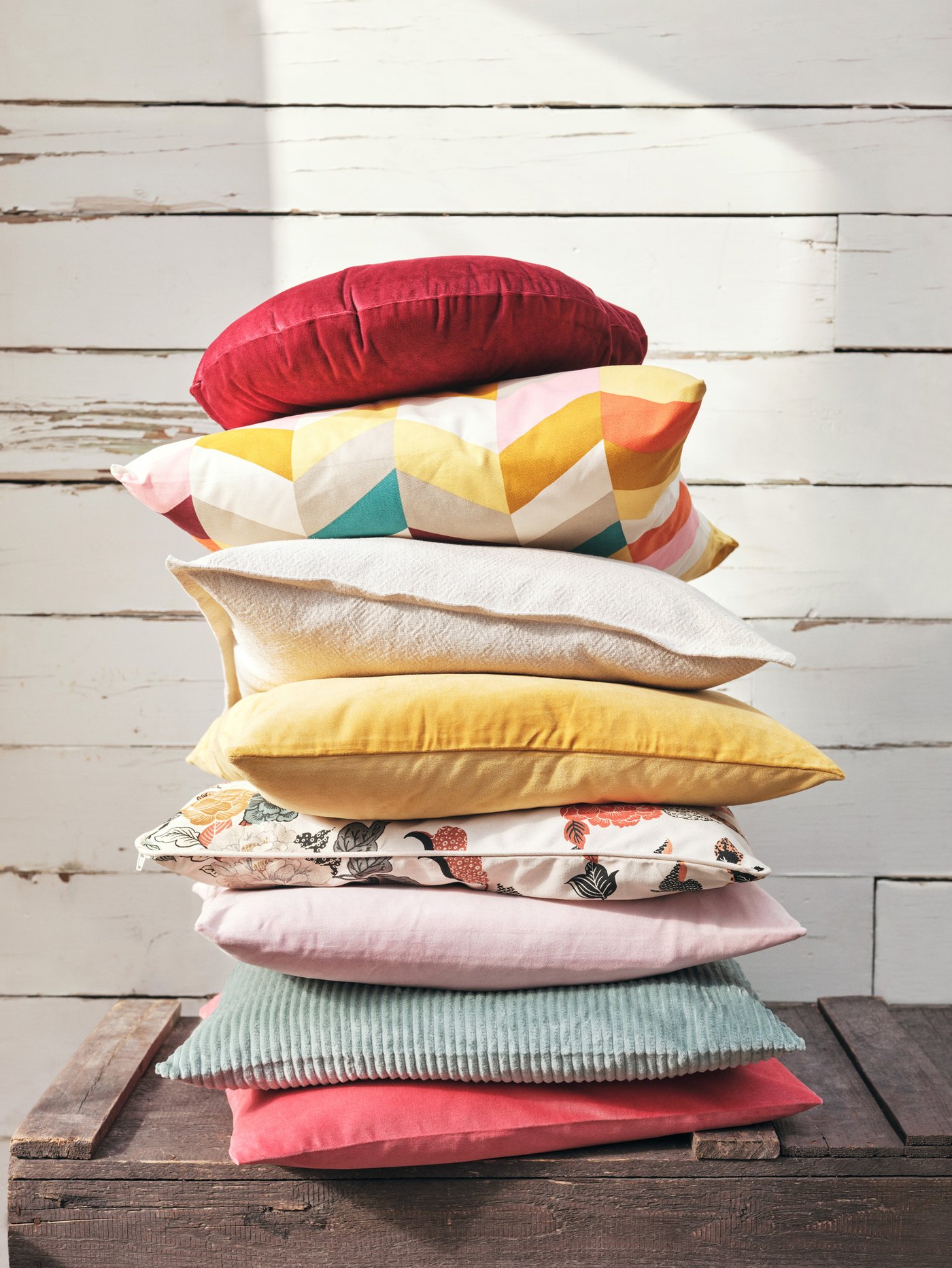 Una torre de cojines IKEA con diferentes colores.