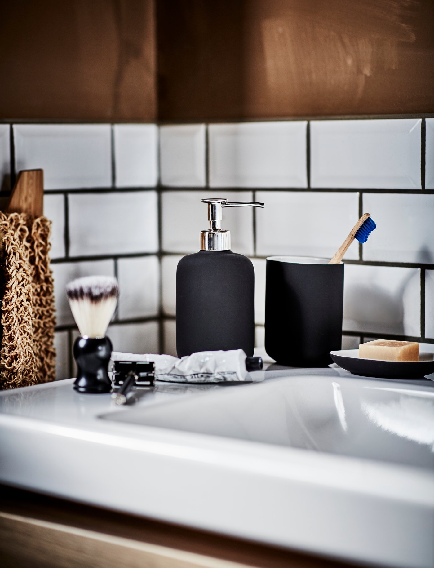 A dark grey EKOLN soap dispenser in the bathroom
