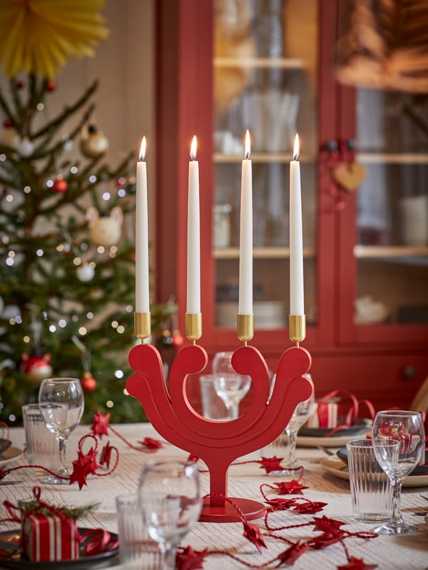 Family raising a toast at Christmas time with ÄNKEBLOMSTER glassware and striped VIPPSTARR tablecloth.