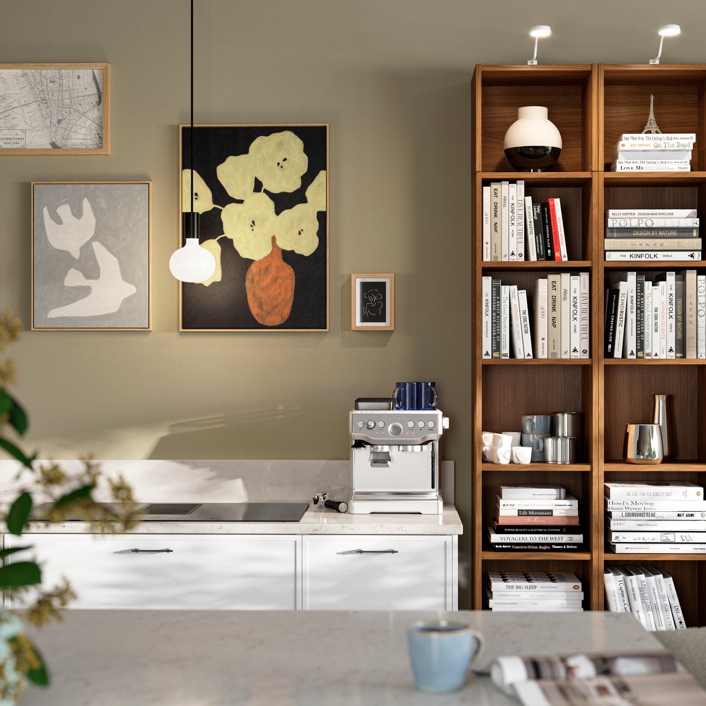 A kitchen with walls filled with pictures including BLODFLÄDER picture beside a wooden bookshelf filled with books and decor.
