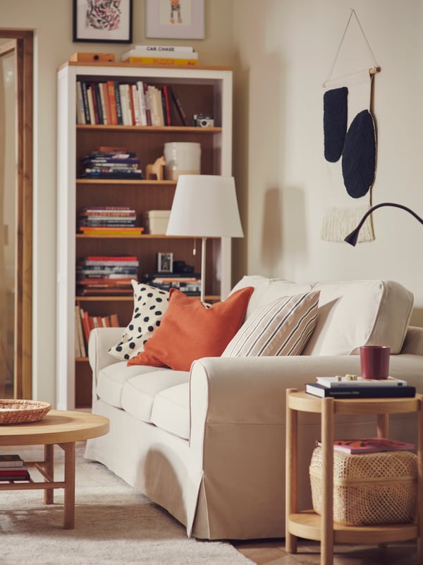 A yellow EKTORP sofa in a living room with colorful pillows
