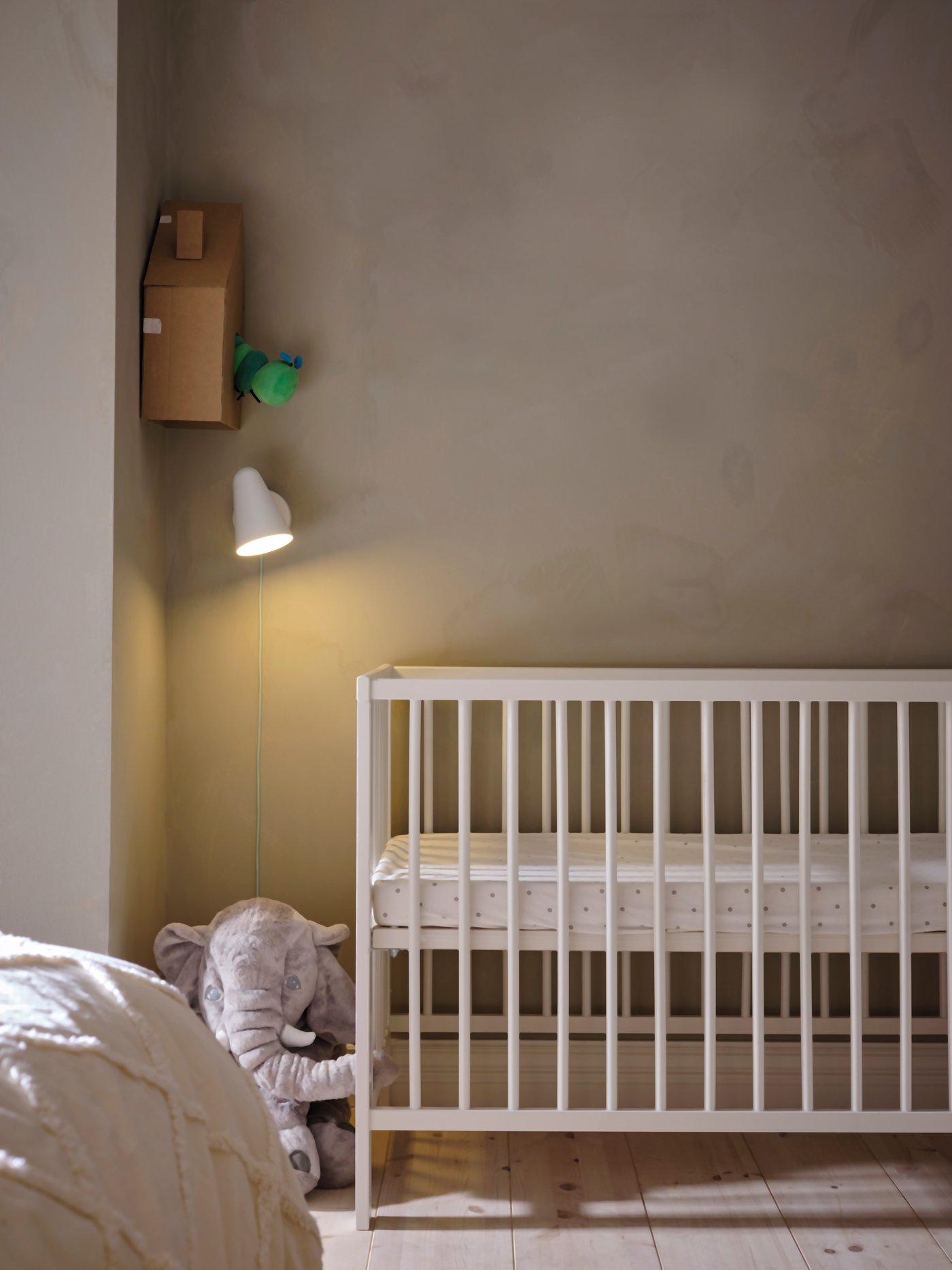 An elephant/grey JÄTTESTOR soft toy in the childrens room