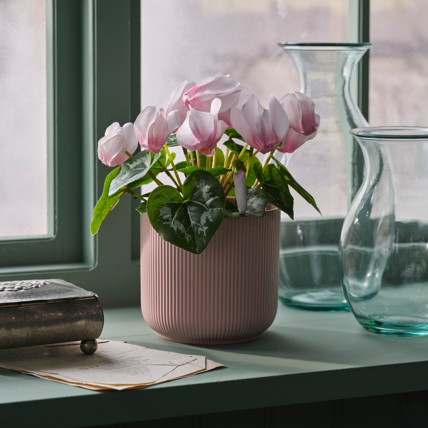 An in/outdoor/assorted colours HONUNGSPALM plant pot in a windowsill