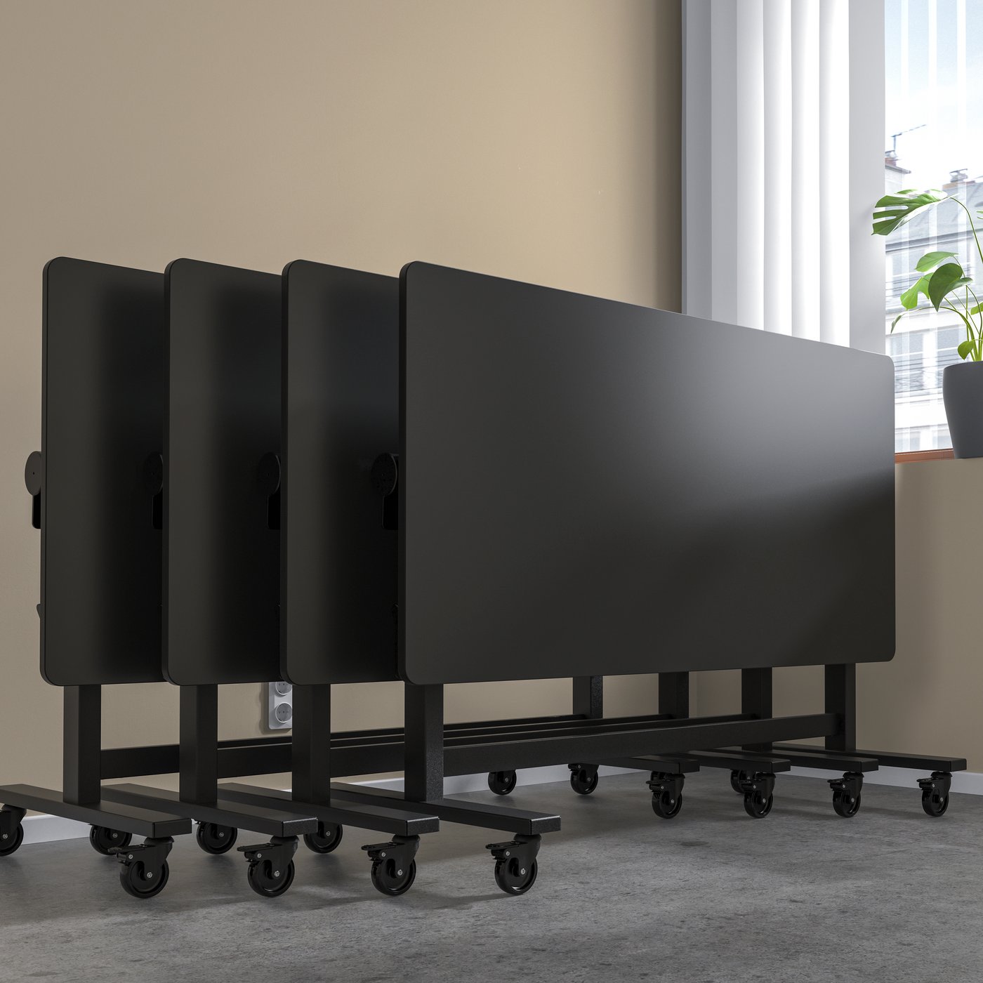 A black MITTZON folding table with wheels