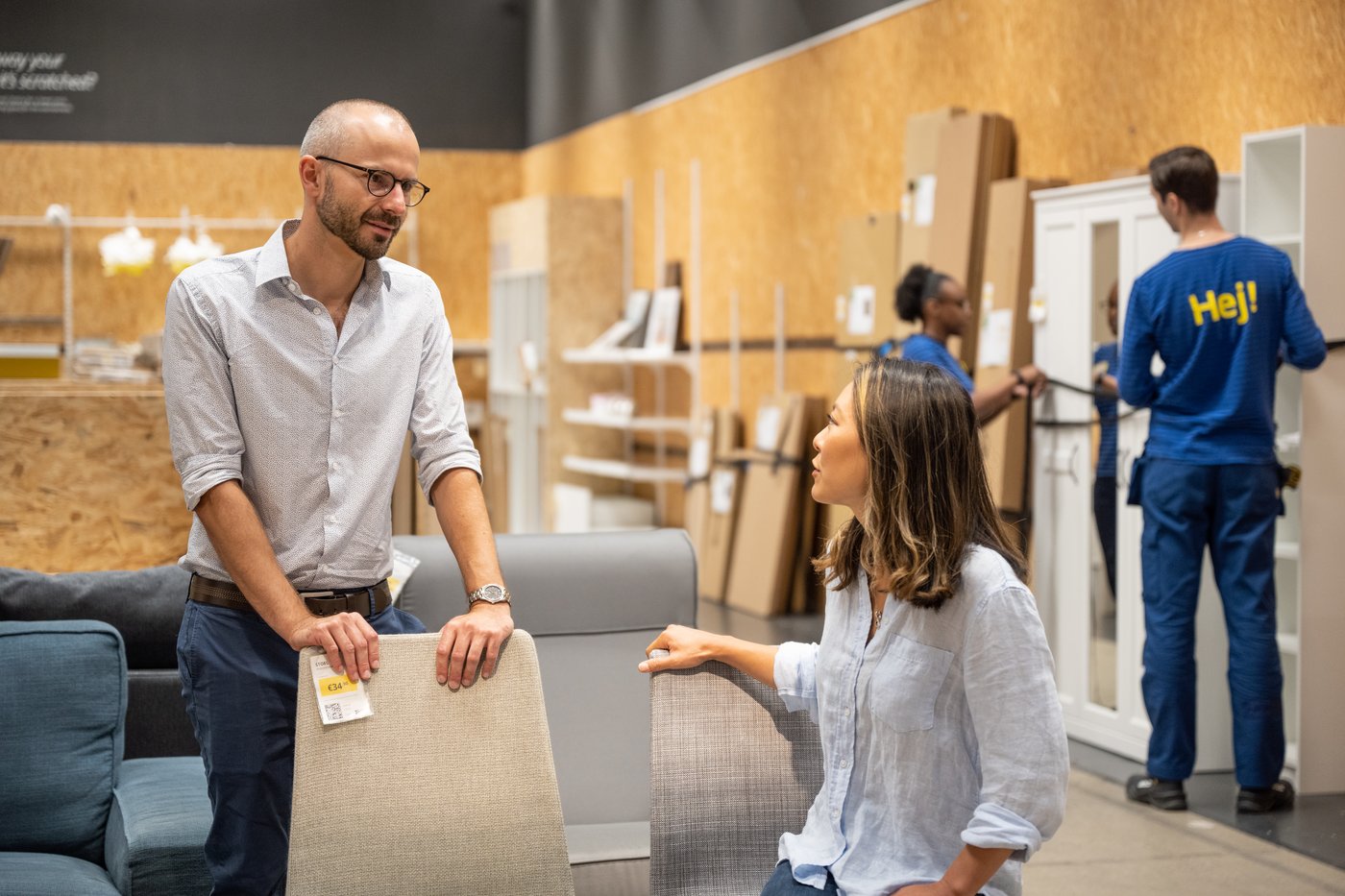Two people are talking to each other in the As-is section of an IKEA store.