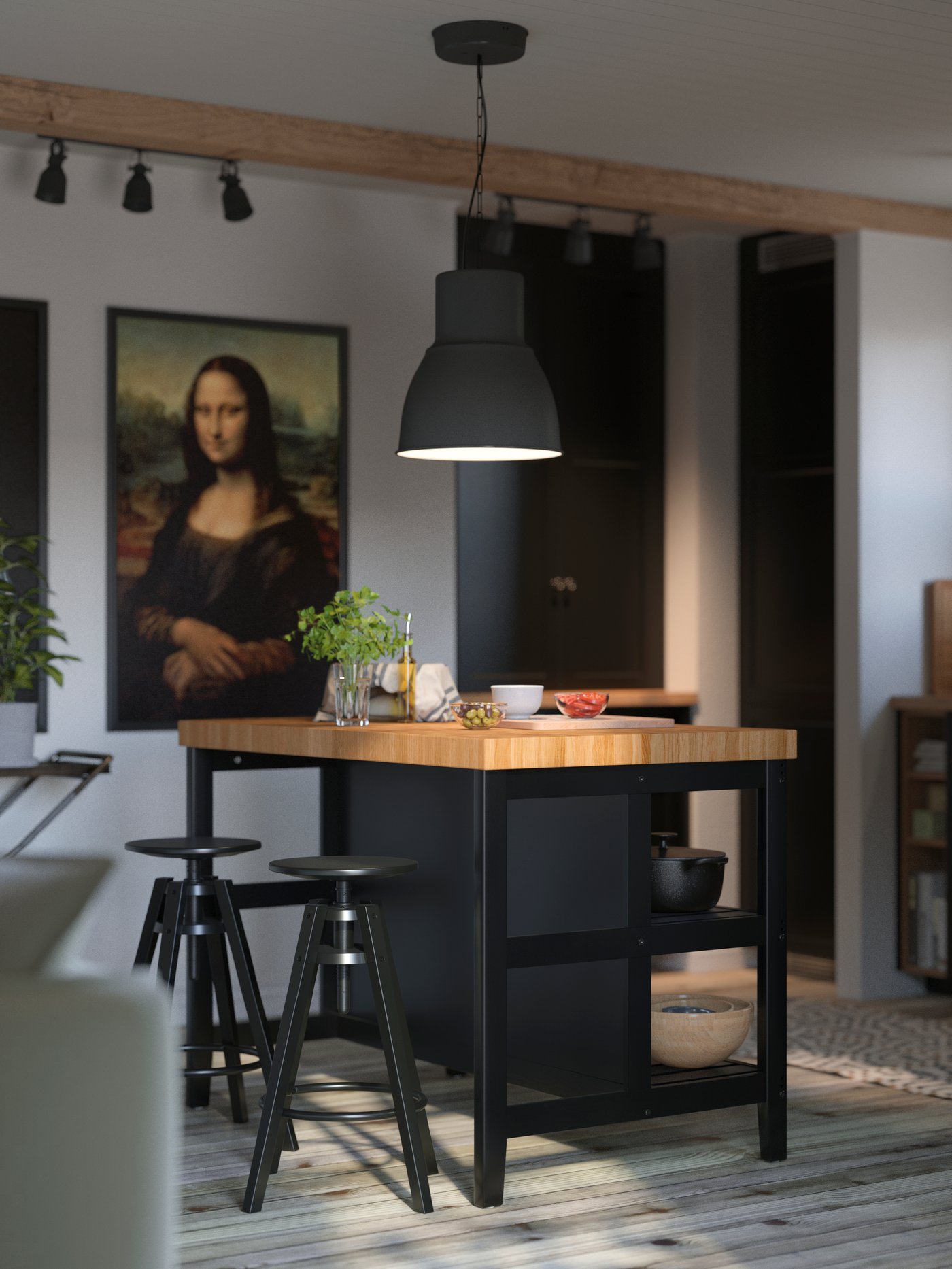 A VADHOLMA kitchen island in black and oak with a black pendant lamp above it and two stools in a white kitchen with beams.
