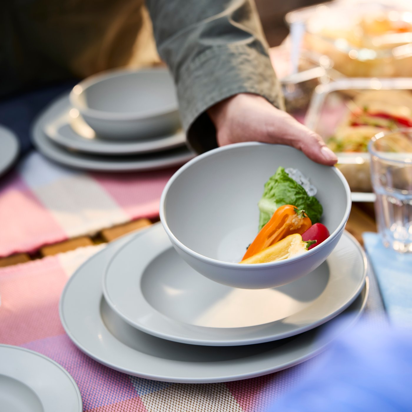 A plastic/green-grey SIMKRABBA bowl outside