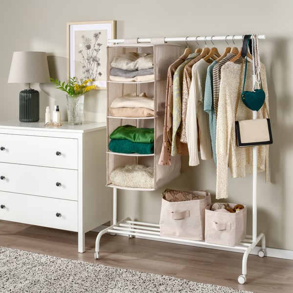 A white RIGGA clothes rack in the bedroom