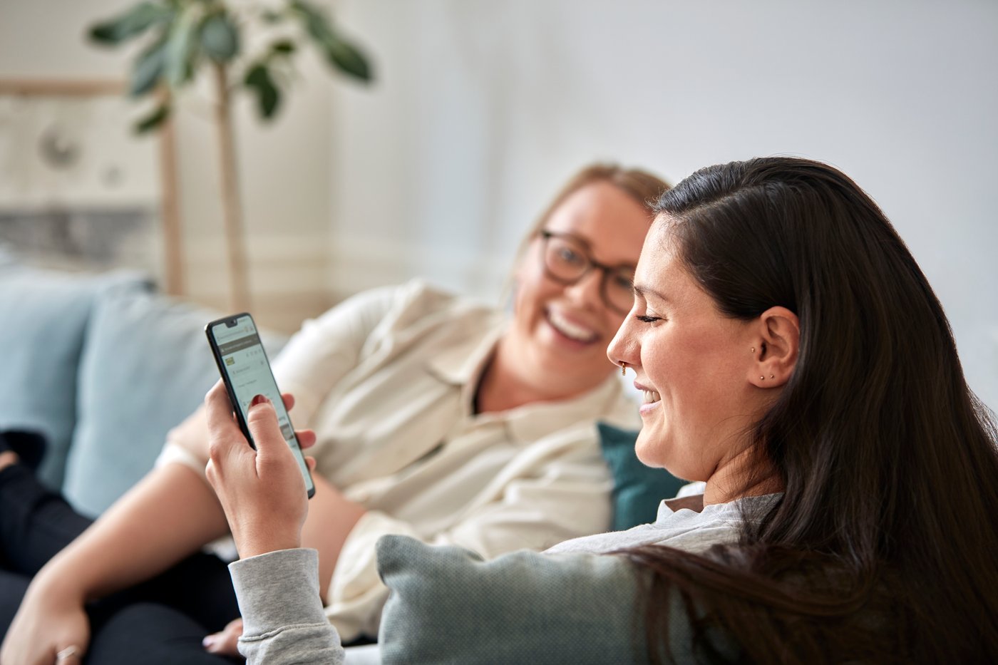 Two women smiling at a phone