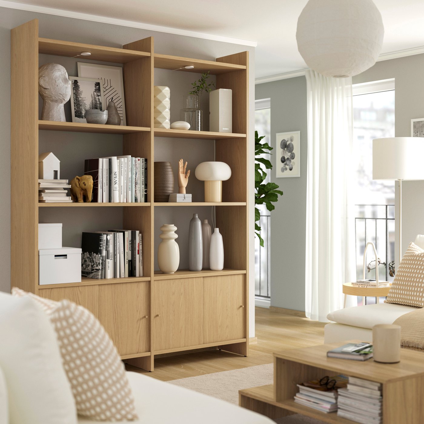 LÅDMAKARE storage combination with six shelves and sliding doors in oak effect finish in a living room.