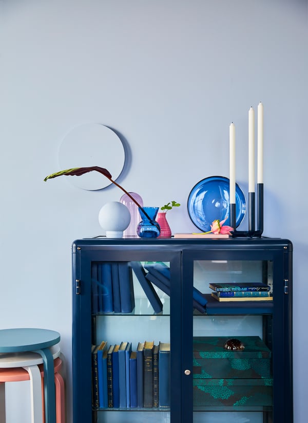 A black-blue FABRIKÖR glass-door cabinet outside