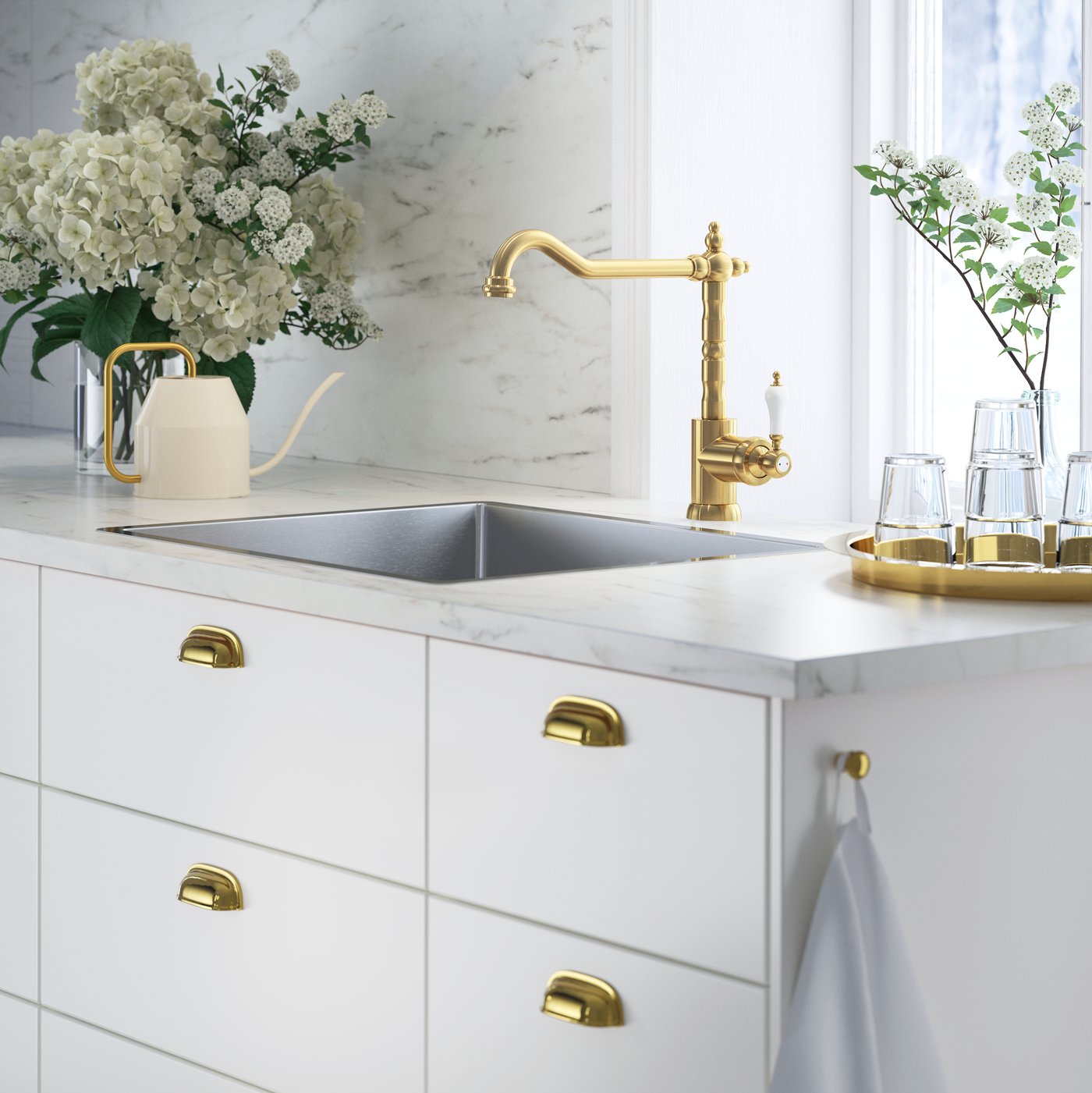 A brass-colour GLITTRAN kitchen mixer tap in the kitchen