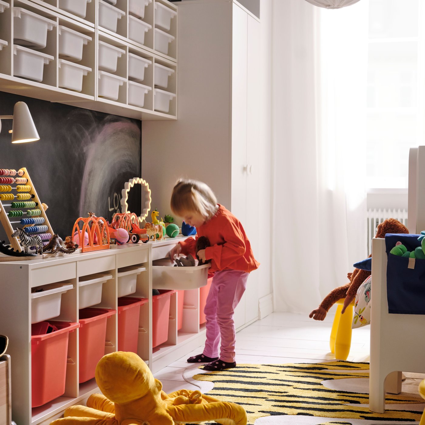 A white white/orange TROFAST storage combination with boxes