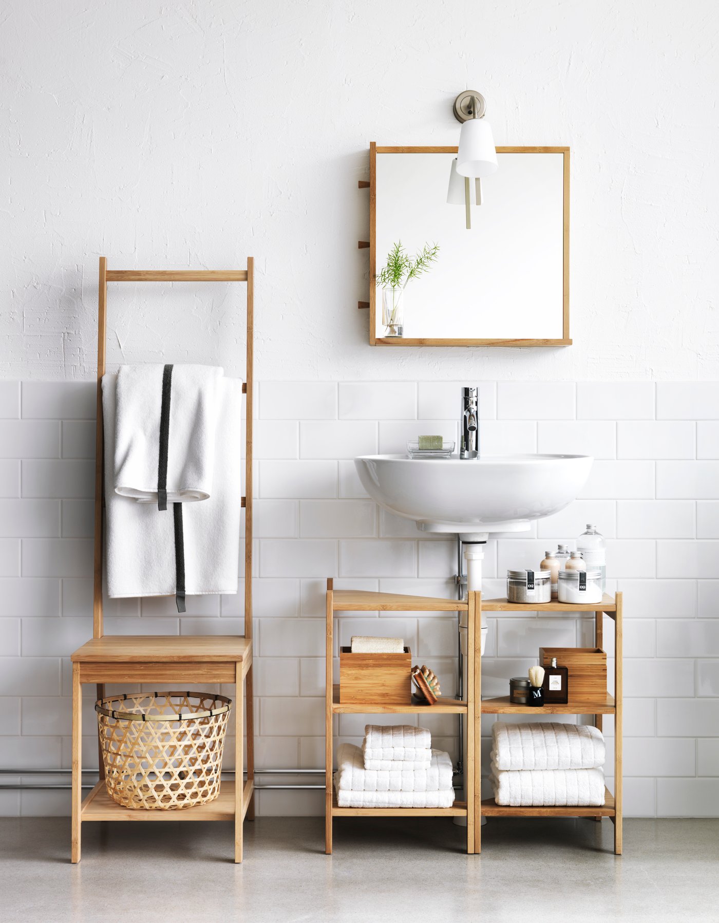 A bright, modern bathroom featuring bamboo furniture, including a towel ladder, shelving under a wall-mounted sink, and a matching mirror.
