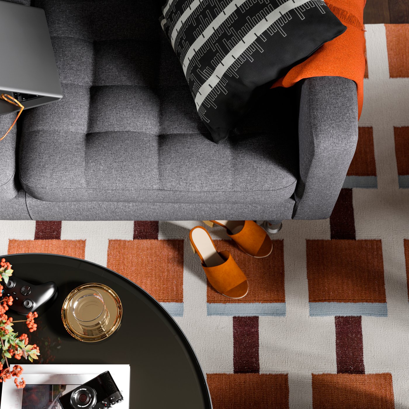 A dark grey 2-seat sofa stands on a STOCKHOLM 2025 rug opposite a FRÖTORP coffee table in a living room.